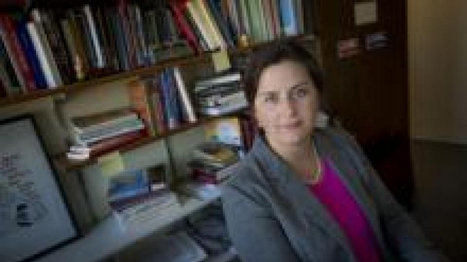 Mirya Holman sits in front of book shelf