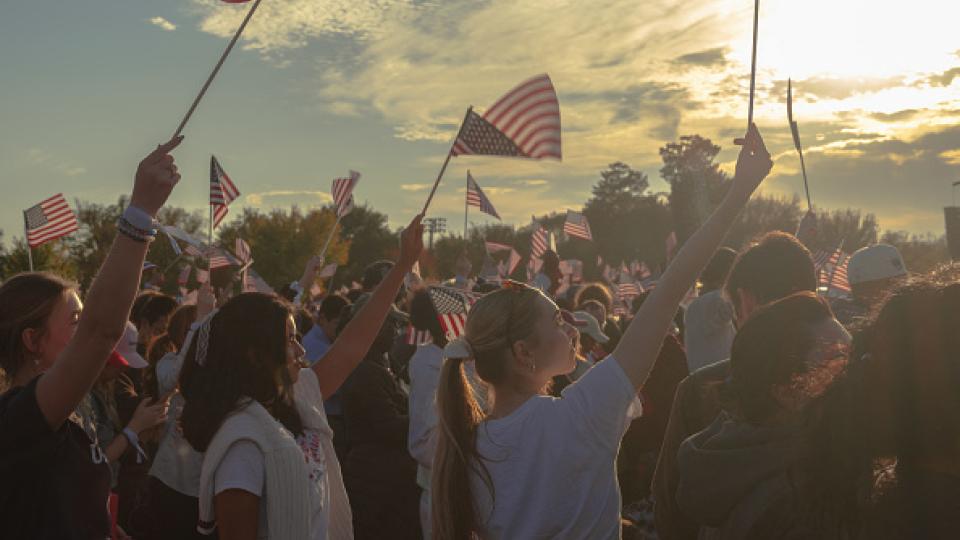 Image of women waving American flags