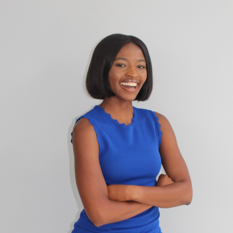 Medinah Muhammad smiling with her arms crossed 