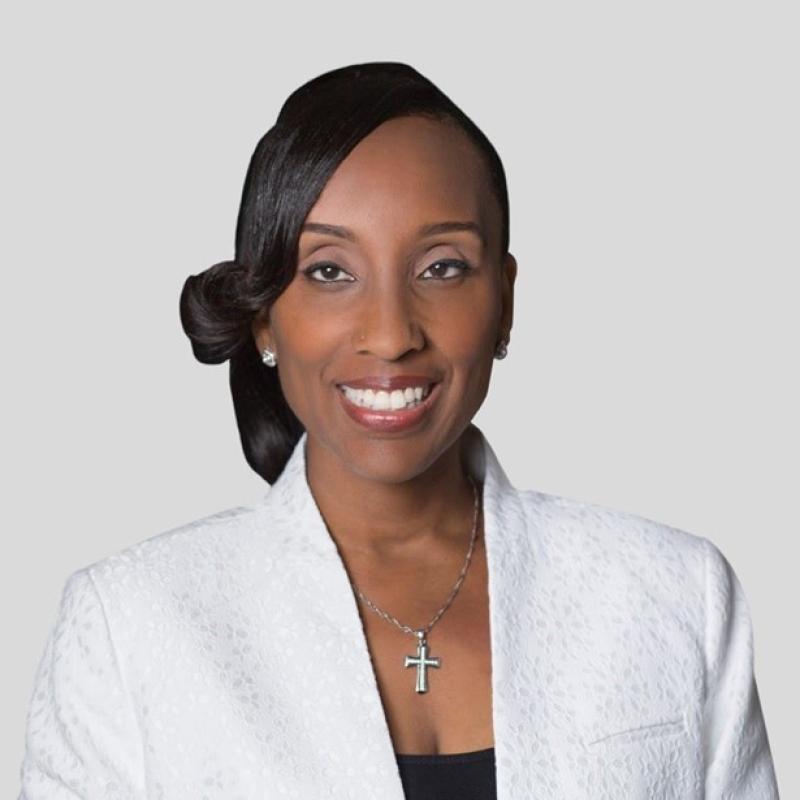 A black woman wearing a white suit 