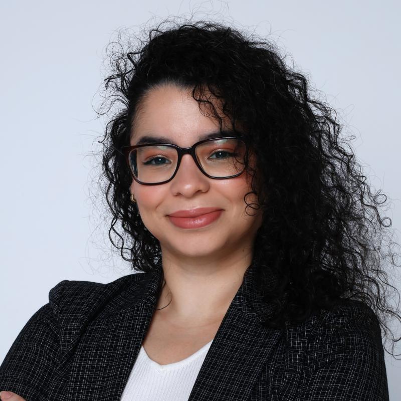 Vereliz Santana with her arms crossed, smiling at the camera