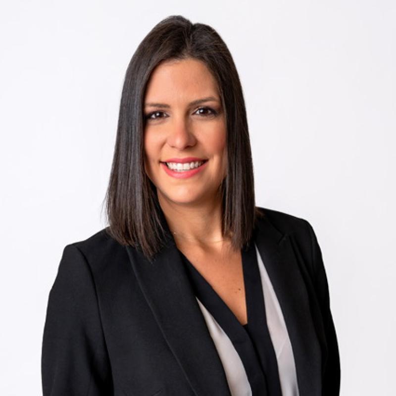 Committeewoman Jessica Rafeh in a black blazer against a white backdrop