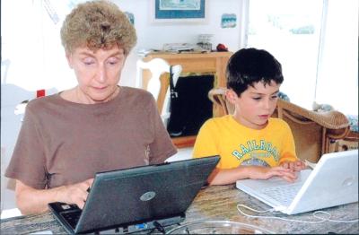 Ruth and grandson working at their laptops
