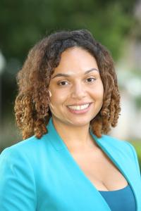 Head shot of Petra Gaskins wearing a green jacket against a background of blurred trees