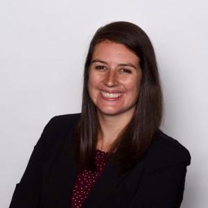 Kylee Britzman in a black blazer in front of a light gray background