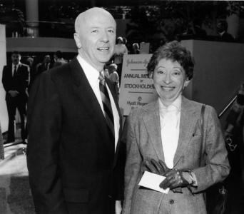 Two people side by side, wearing suits