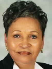 Mildred Scott poses in black suit with white collar