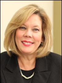 Nilsa Cruz-Perez smiles in black suit