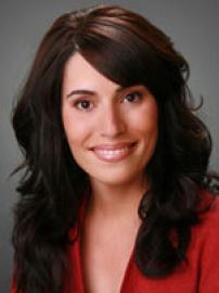 M. Teresa Ruiz smiles in red suit