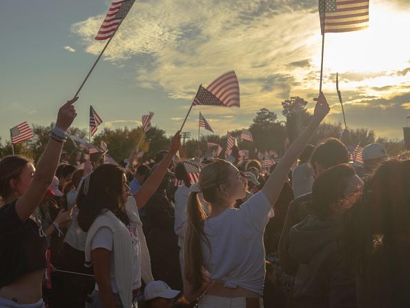 Young women waving American flags